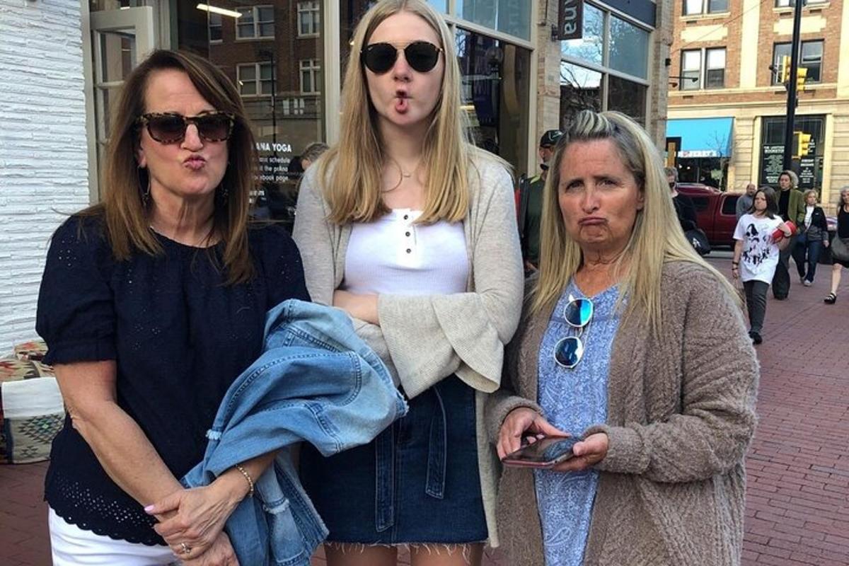 two women standing next to each other on a street
