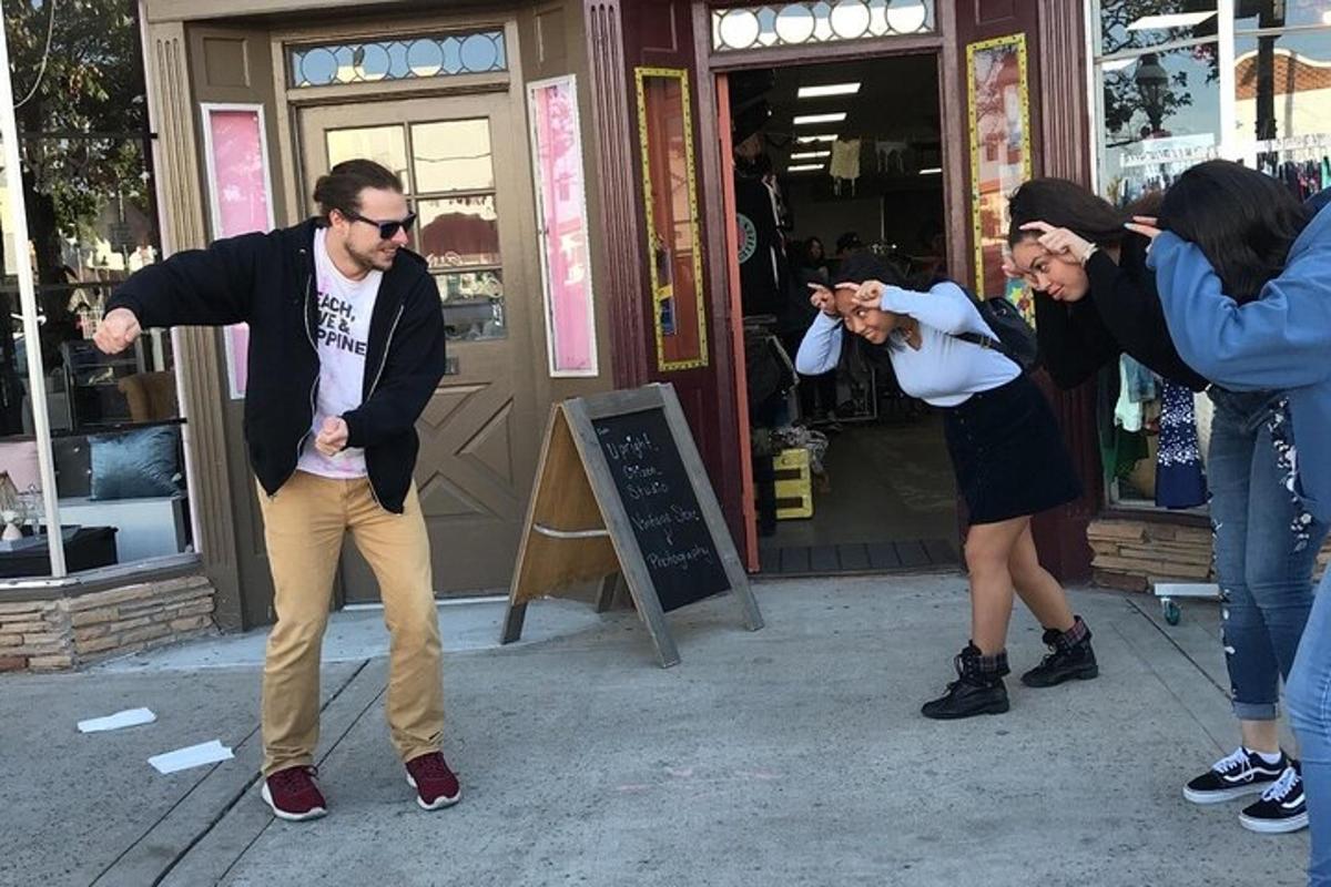 a group of people taking pictures of a man and a woman