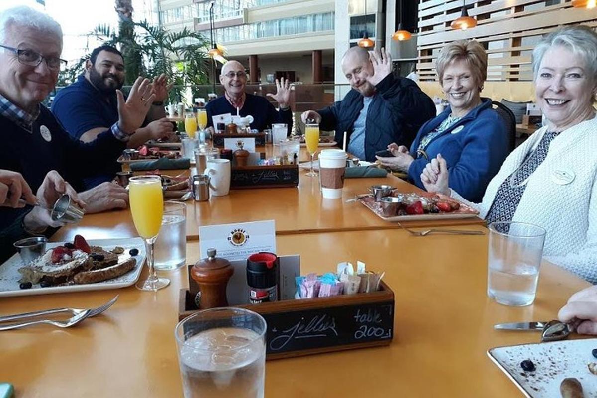 a group of people sitting around a table eating food
