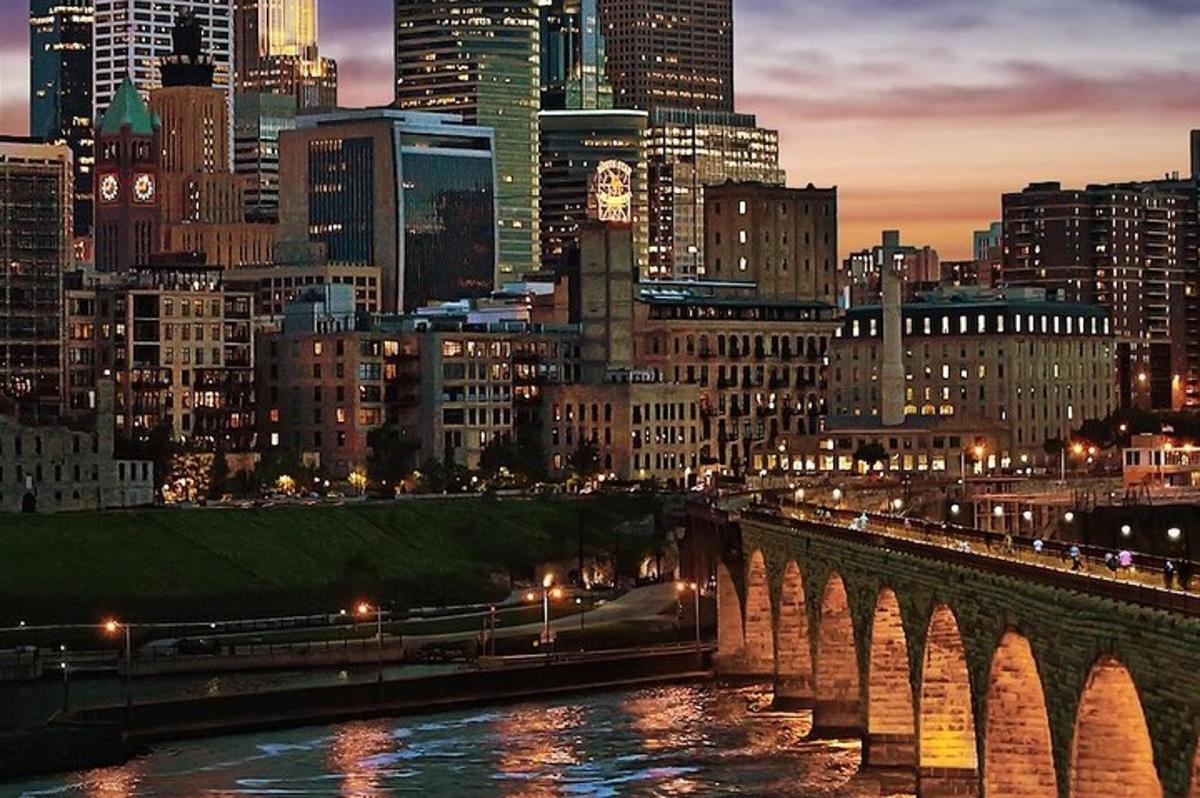 a city skyline with a bridge over a river