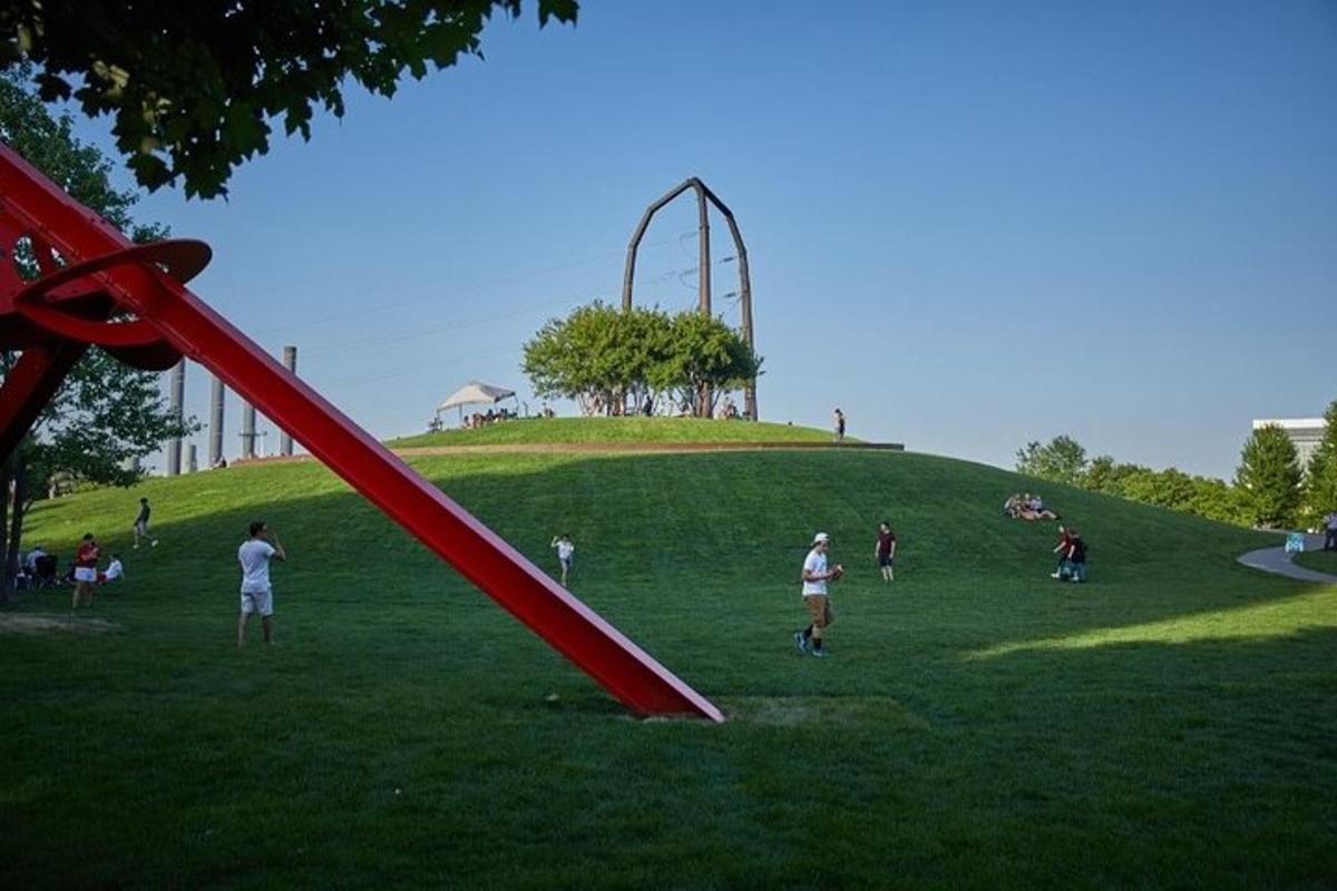 a group of people in a park with a slide