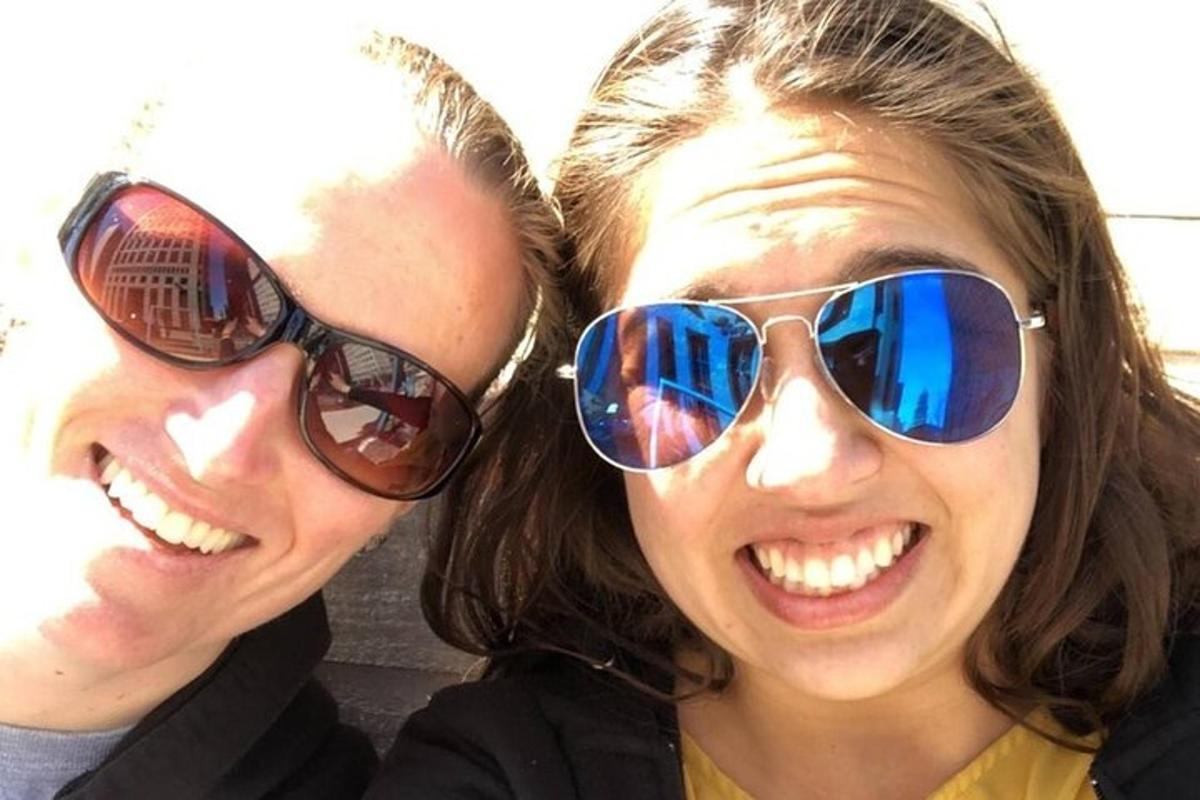 two women wearing sunglasses posing for a picture
