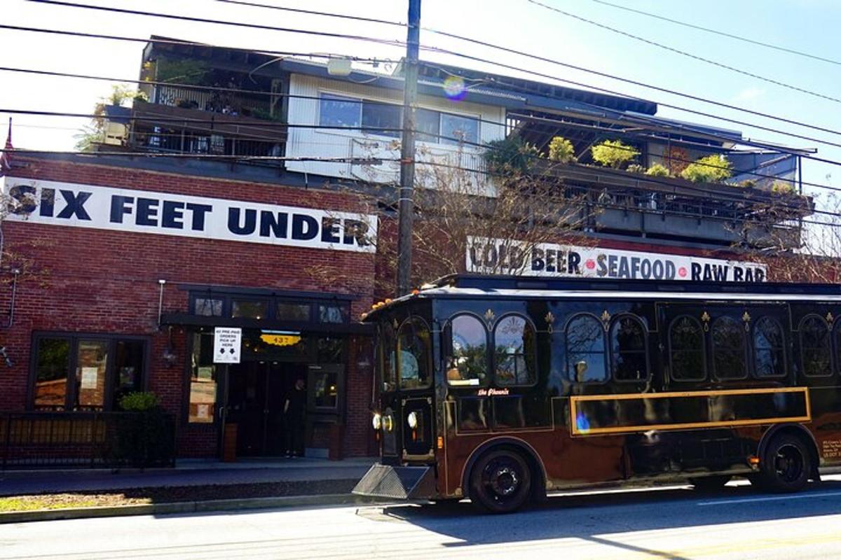 a trolley car parked in front of a brick building