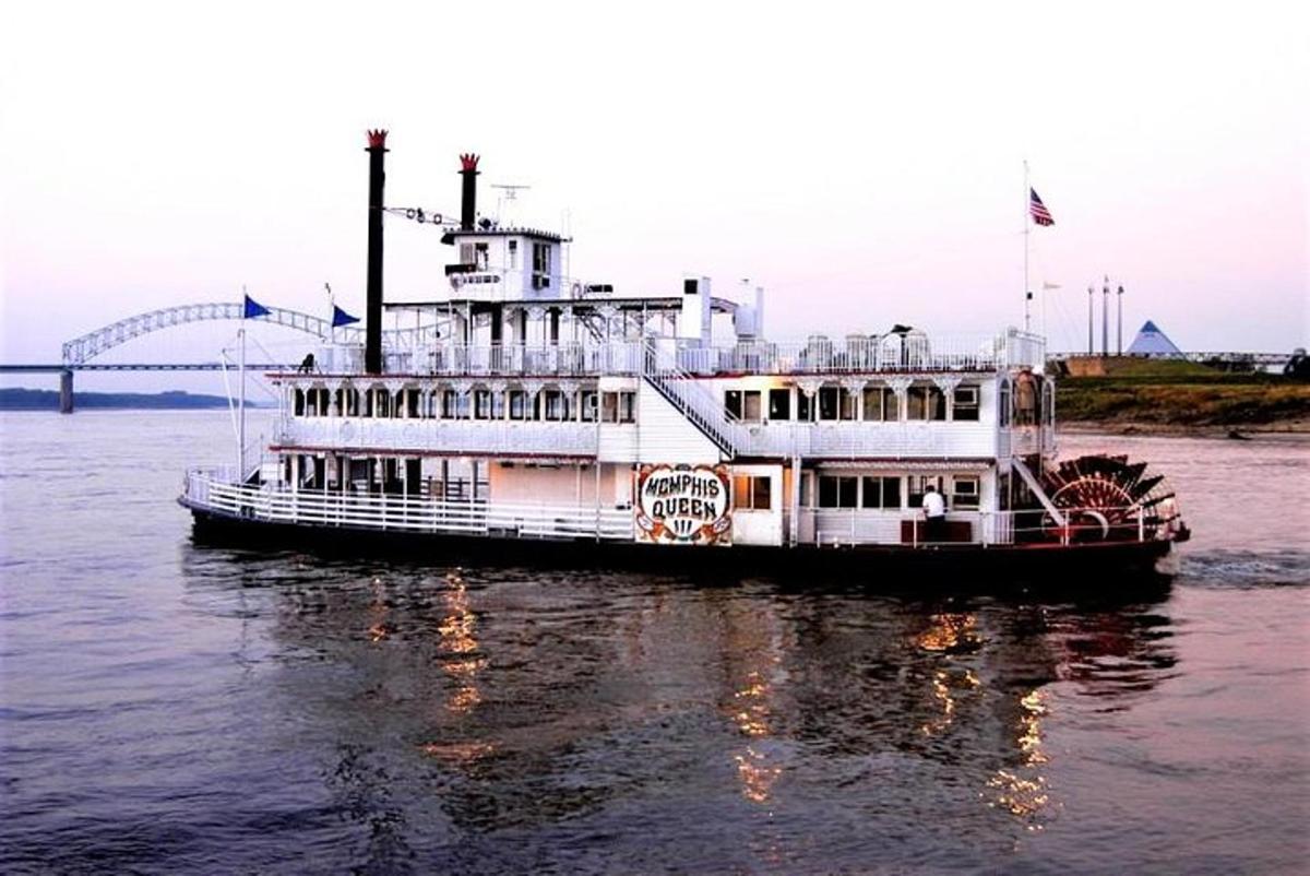 a ferry boat on the water with a bridge in the background