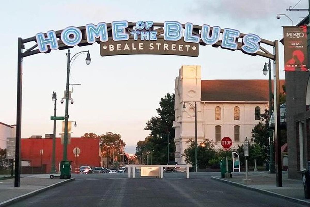 a sign that says home of the blues on a street