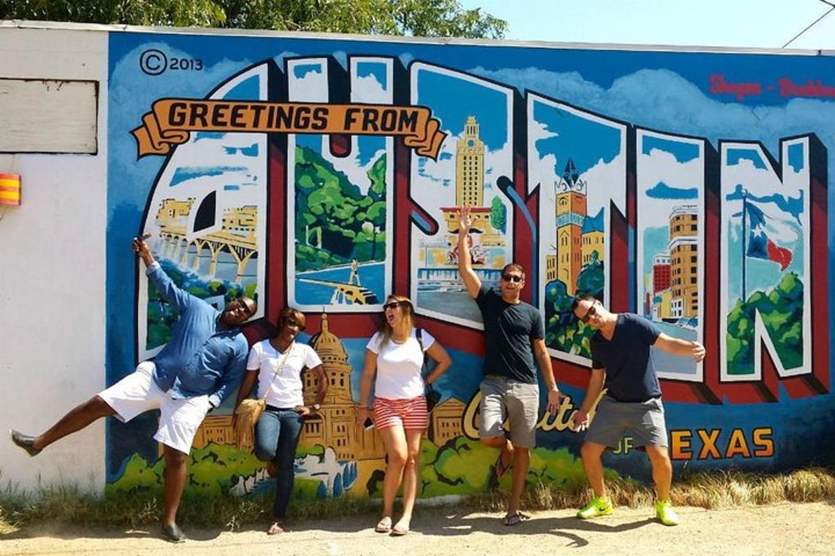 a group of people standing in front of a mural