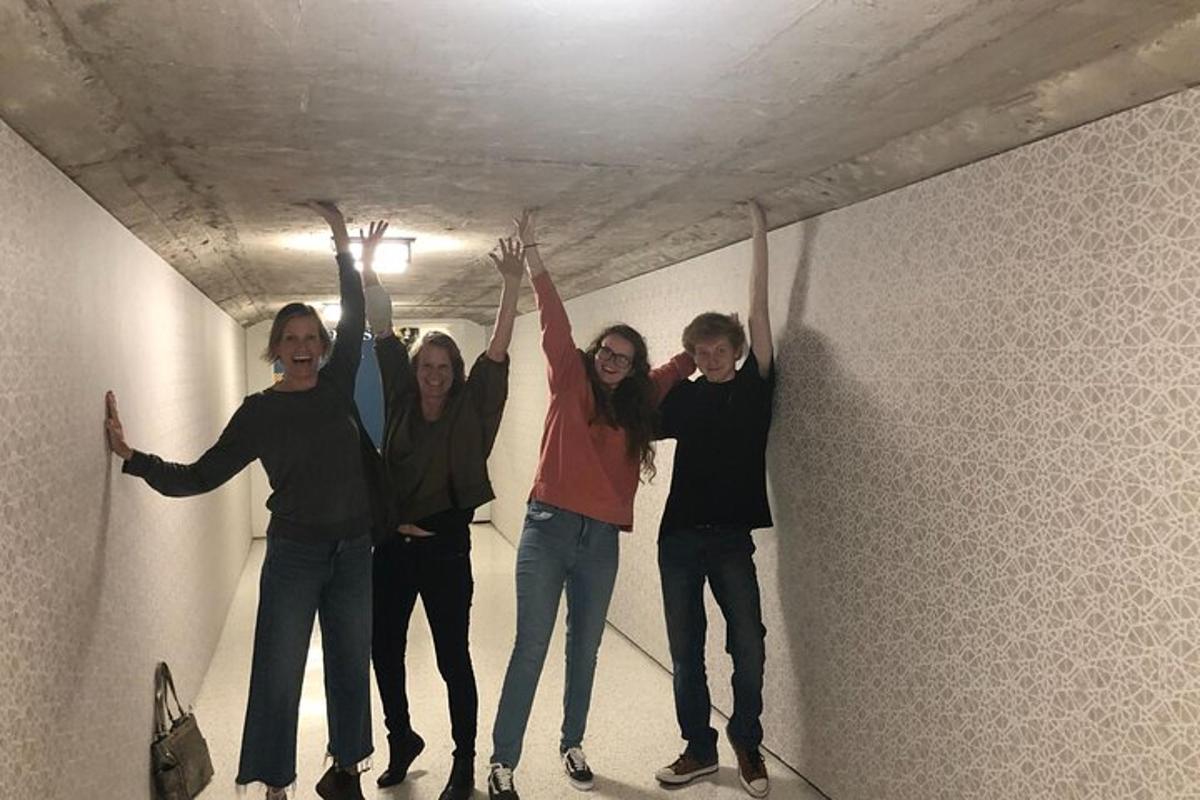 a group of people standing in a hallway with their hands in the air
