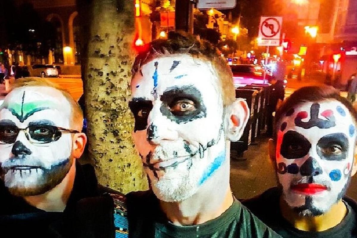 a couple of men with painted faces on their faces