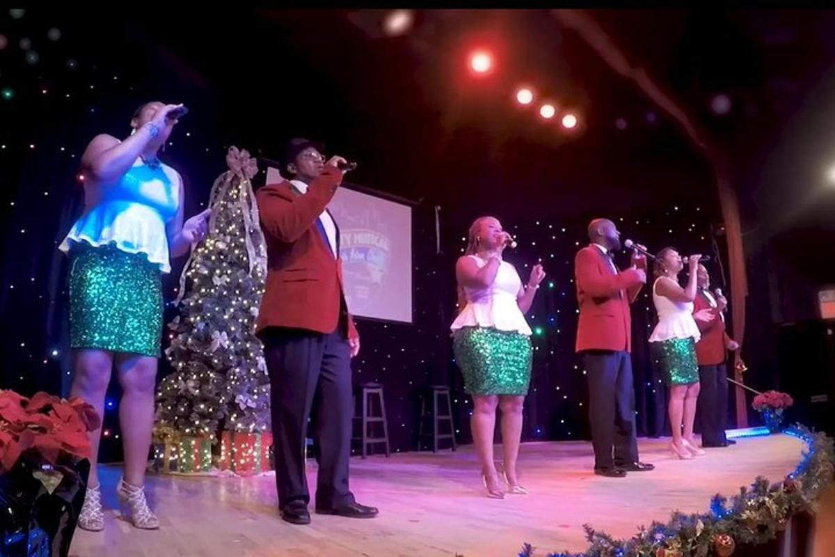 a group of people singing on a stage