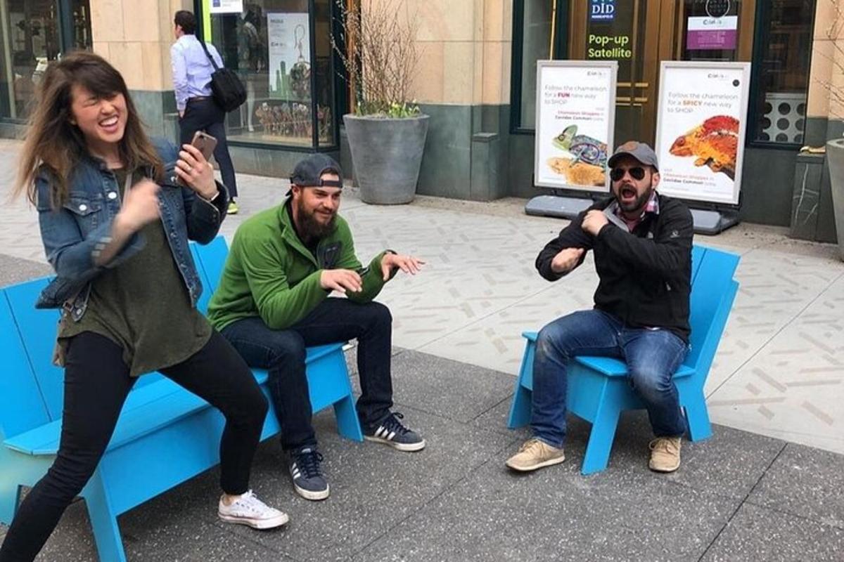 a group of people sitting on a blue bench