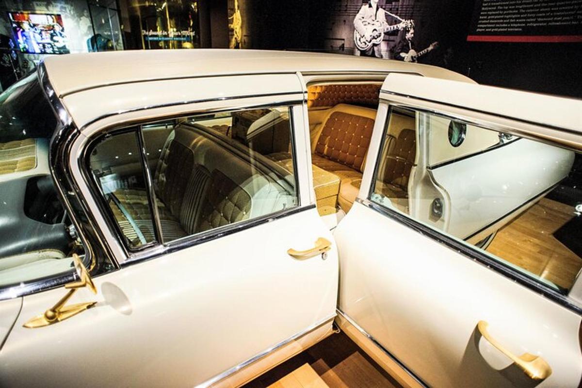 an old white car on display at a museum