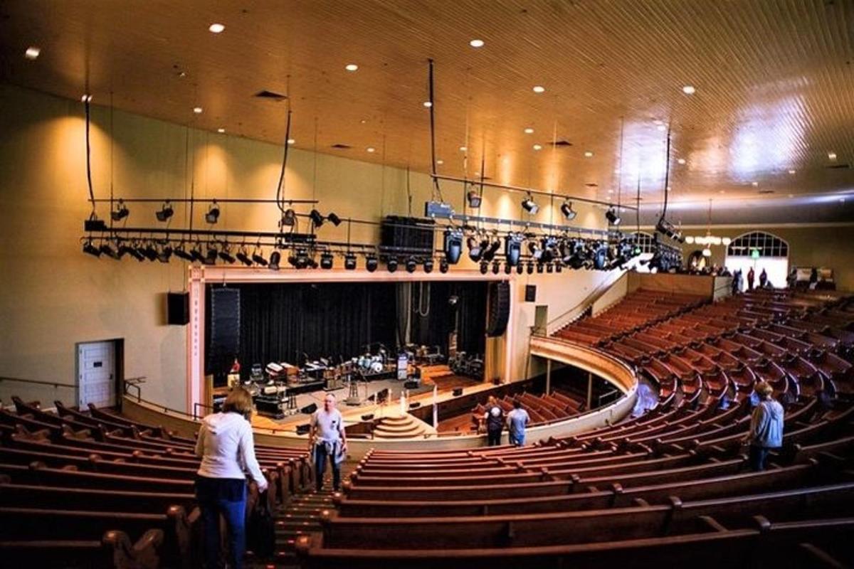 a group of people standing in an auditorium