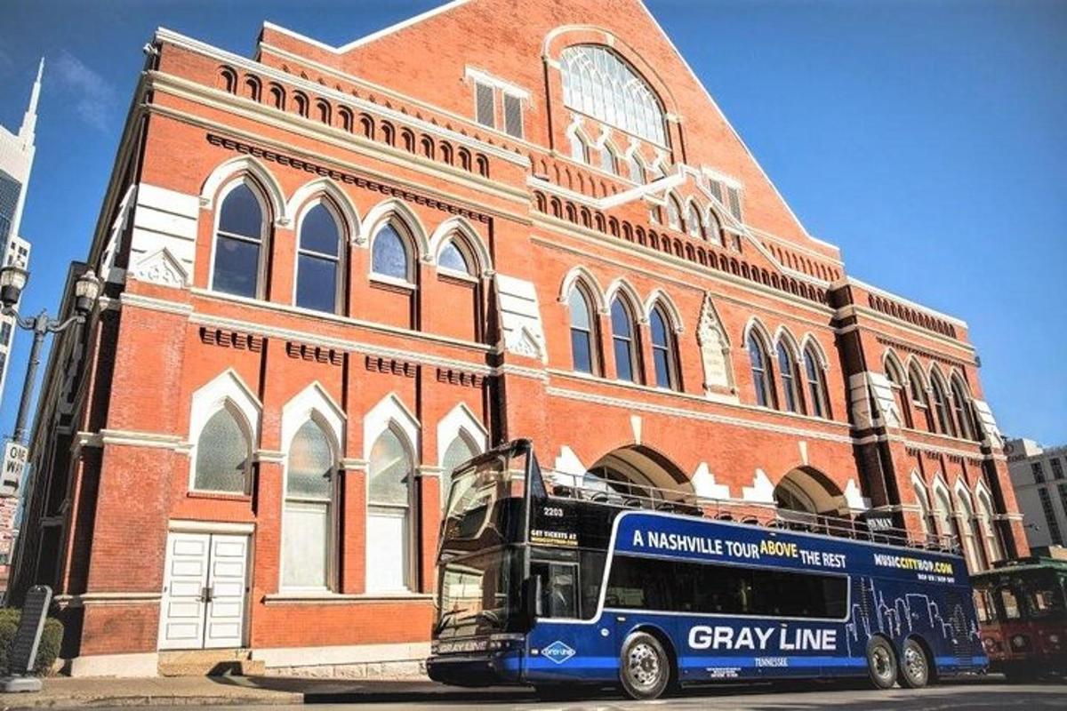 a blue bus parked in front of a brick building
