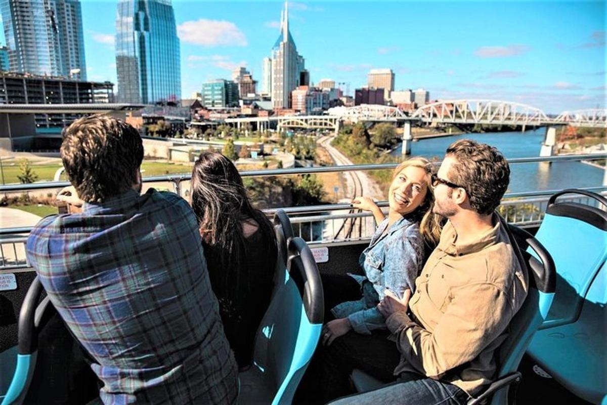 a group of people sitting on a bus looking at the city