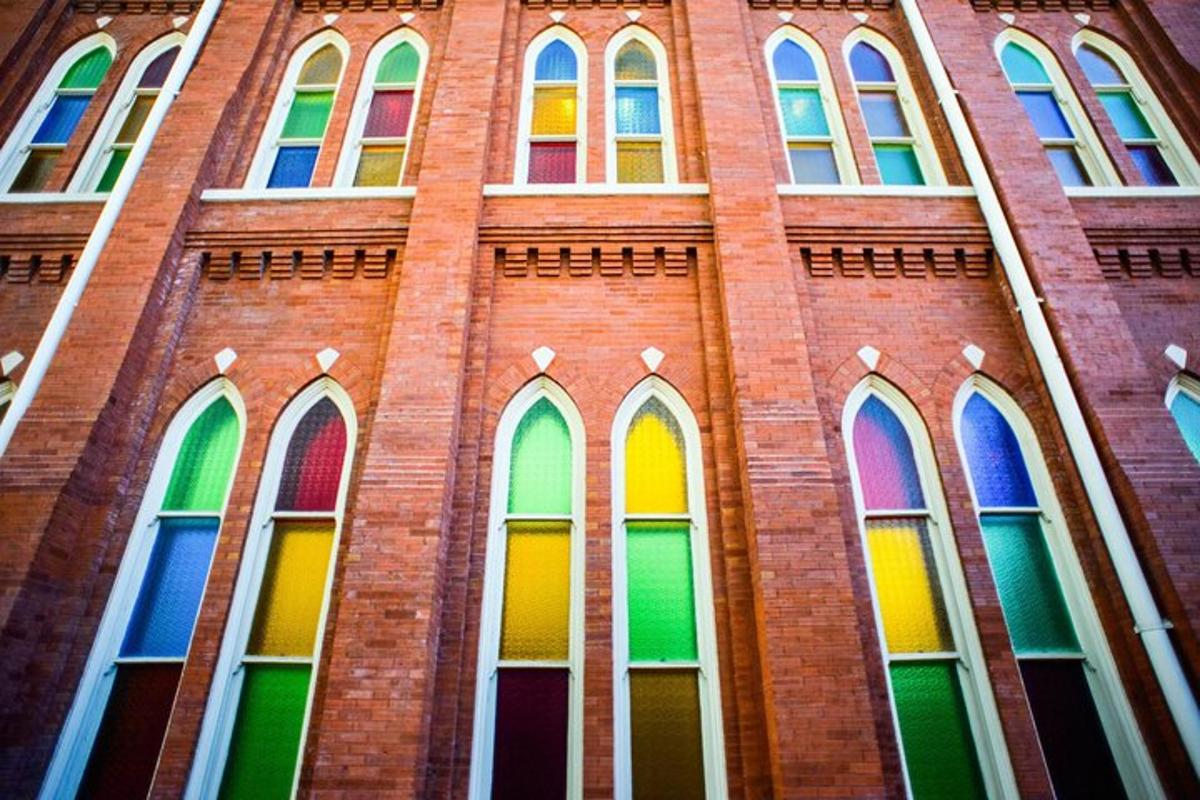 a tall brick building with rainbow windows on it