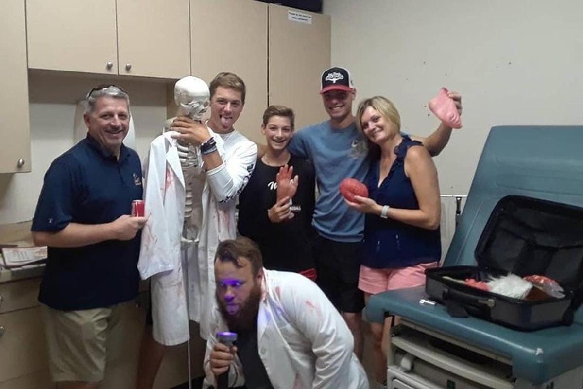 a group of people posing for a picture in a hospital room
