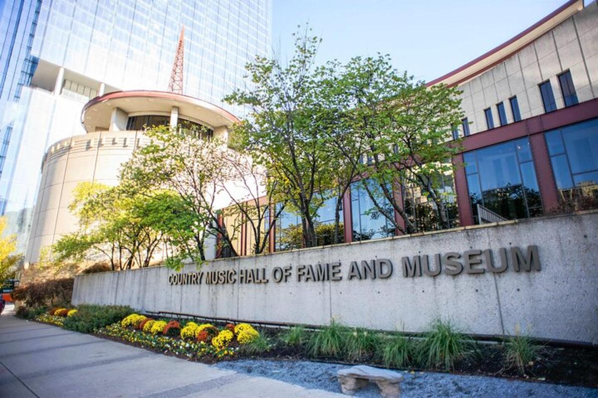 a sign for the university of fame and museum in front of a building