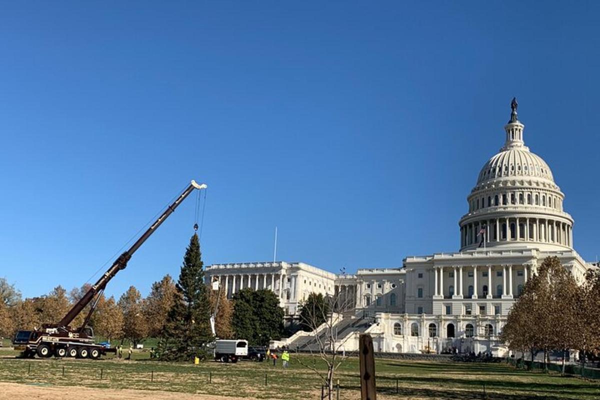 a construction crane in front of the united states capitol building