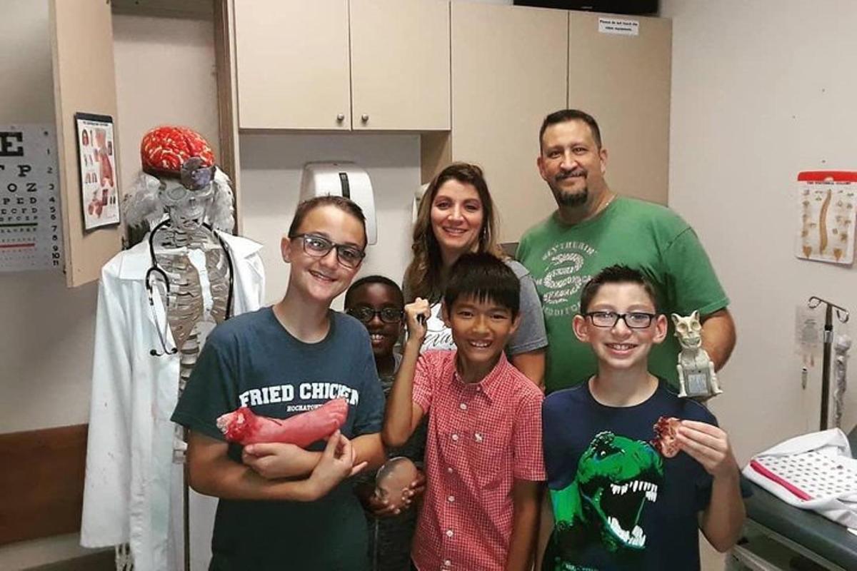a group of people standing in a hospital room