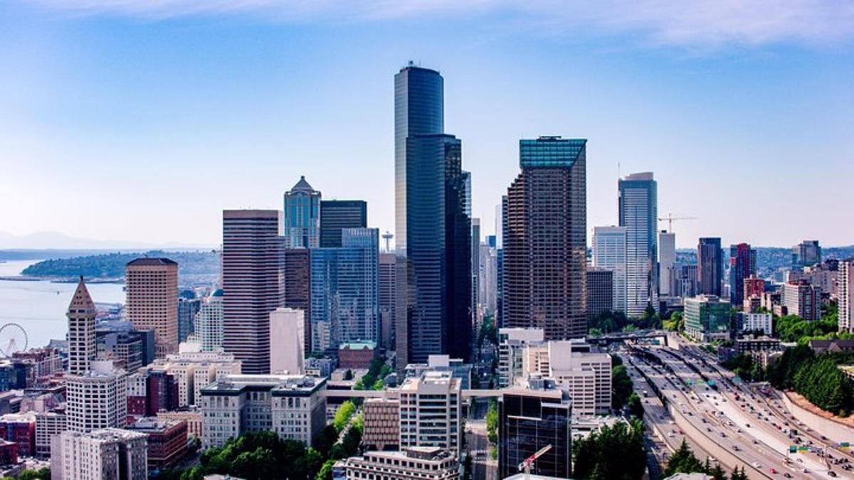 a city skyline with tall buildings and a freeway