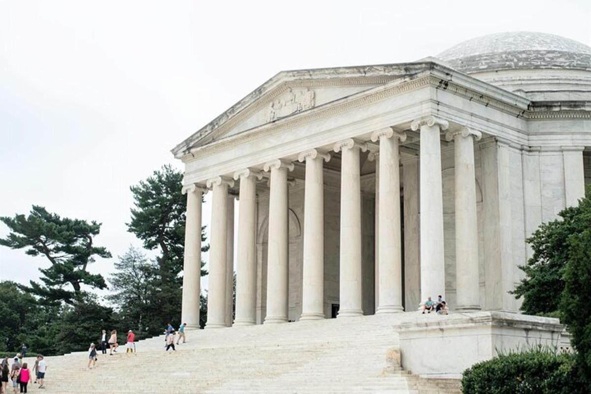 a supreme court building with people walking in front