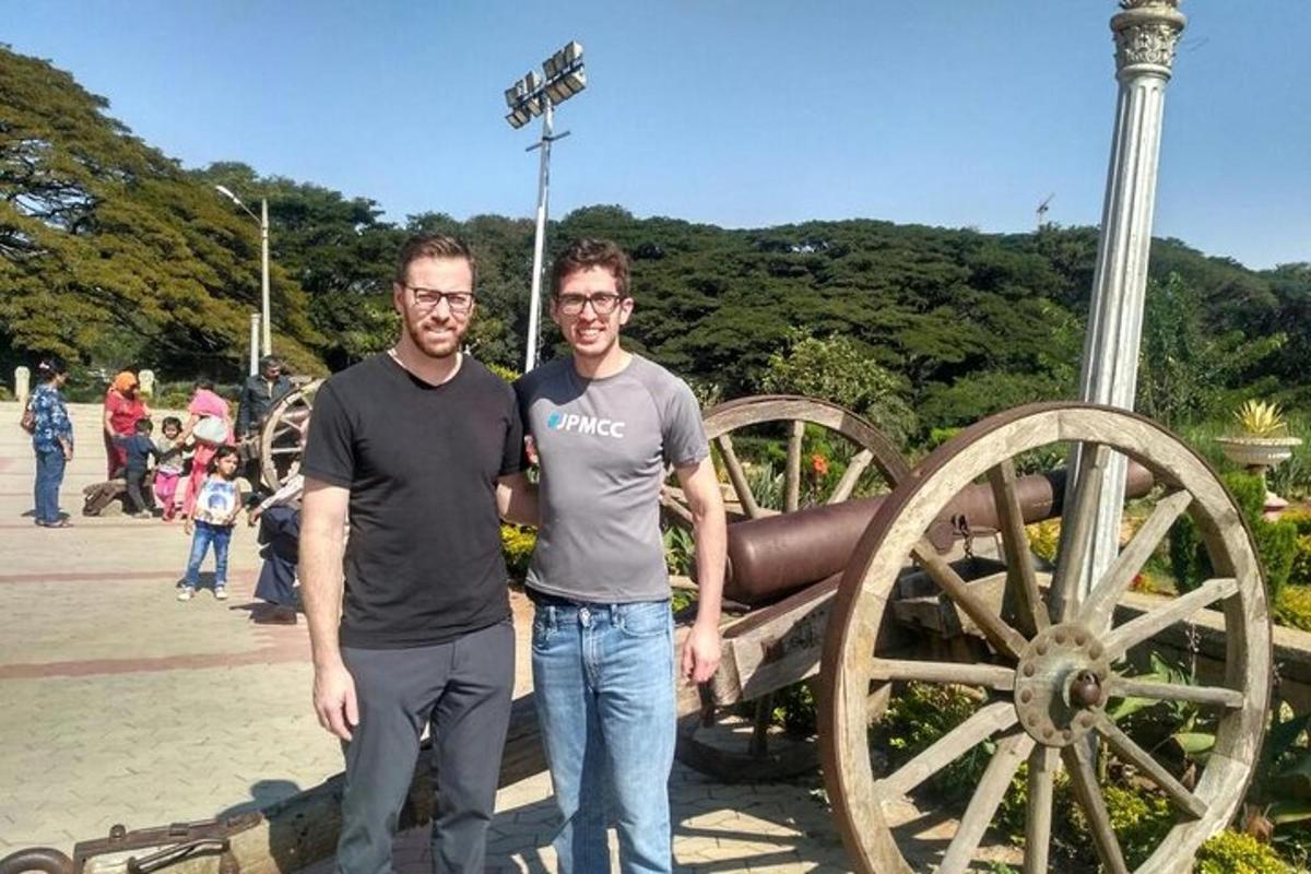 two men standing in front of a cannon