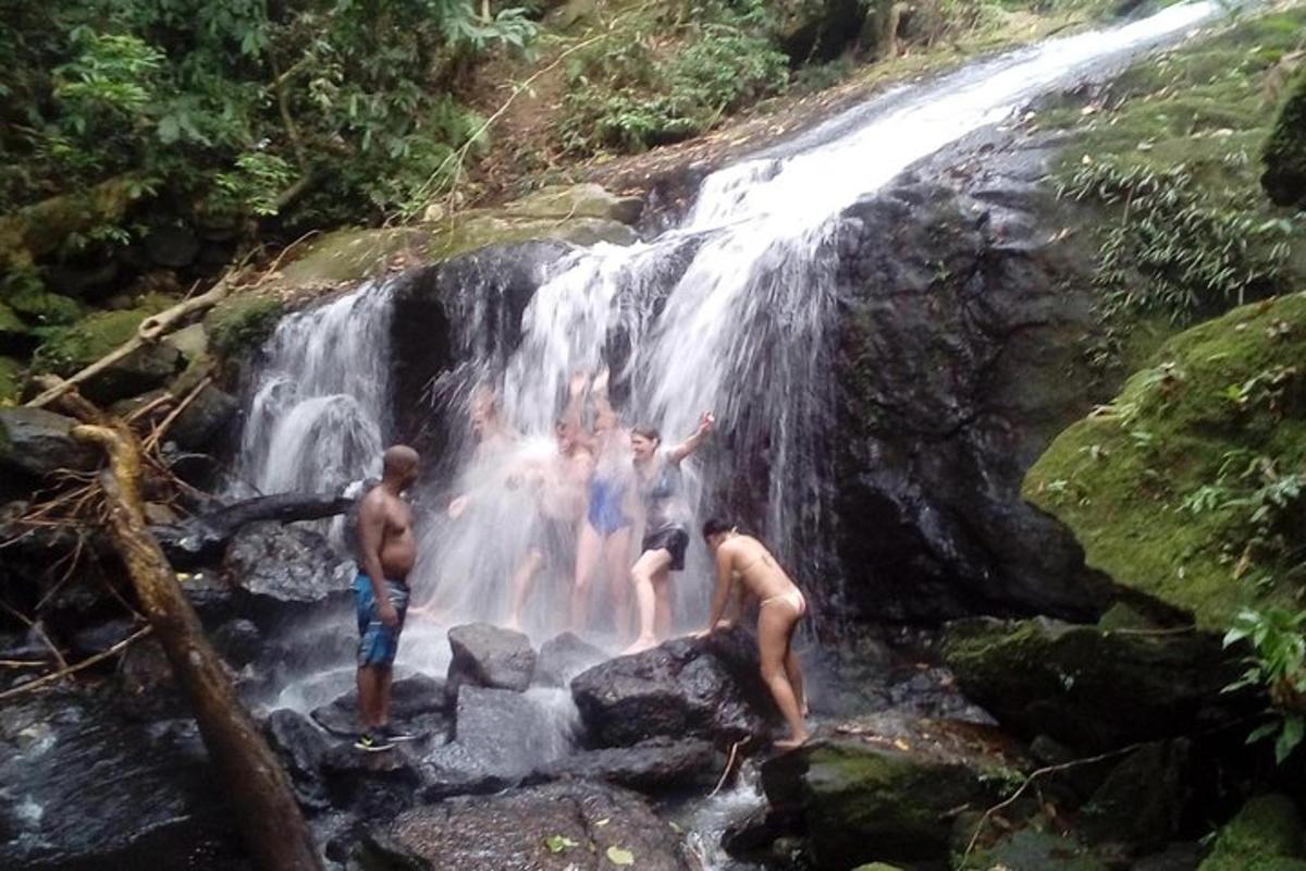 a group of people standing in a waterfall