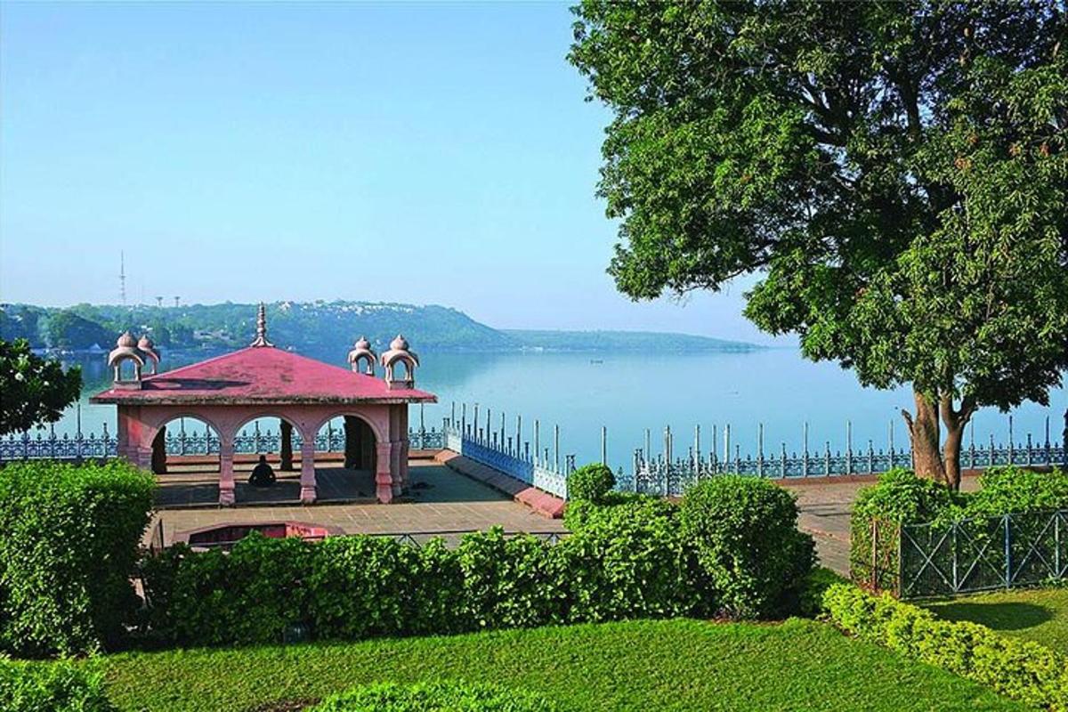 a gazebo in a park next to a lake