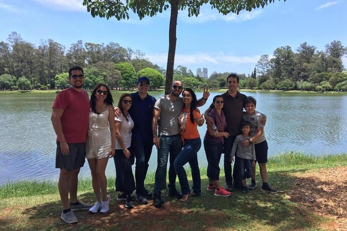 a group of people standing in front of a lake