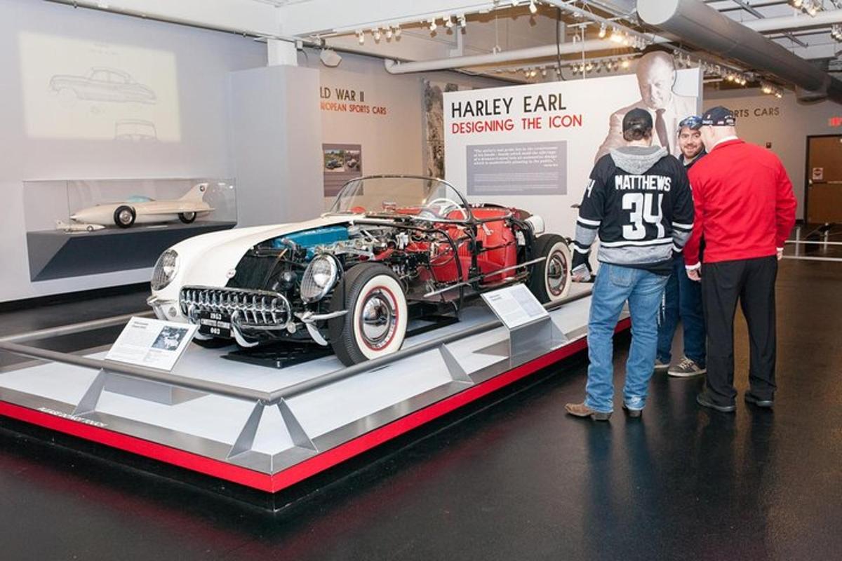a group of people looking at a car on display