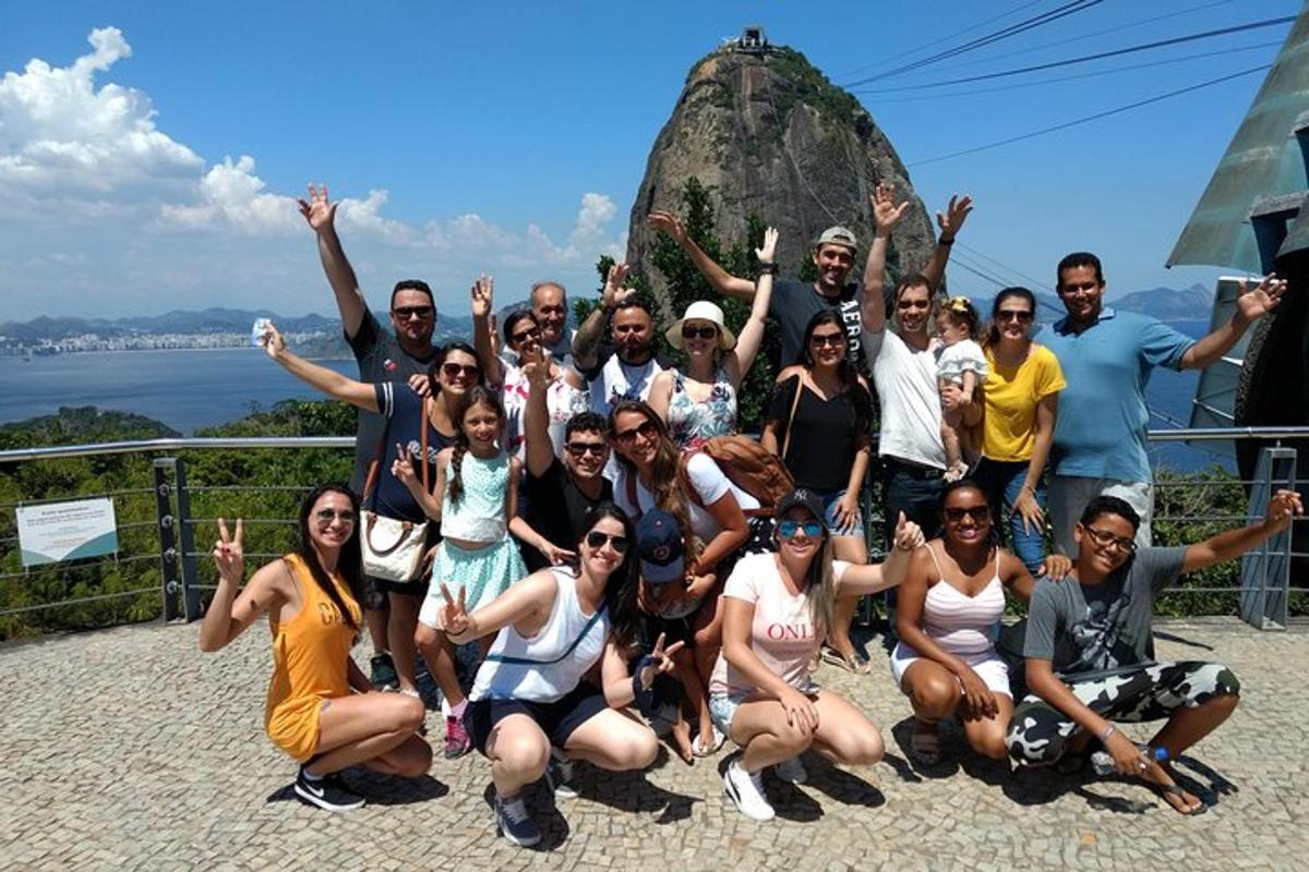 a group of people posing for a picture in front of a mountain