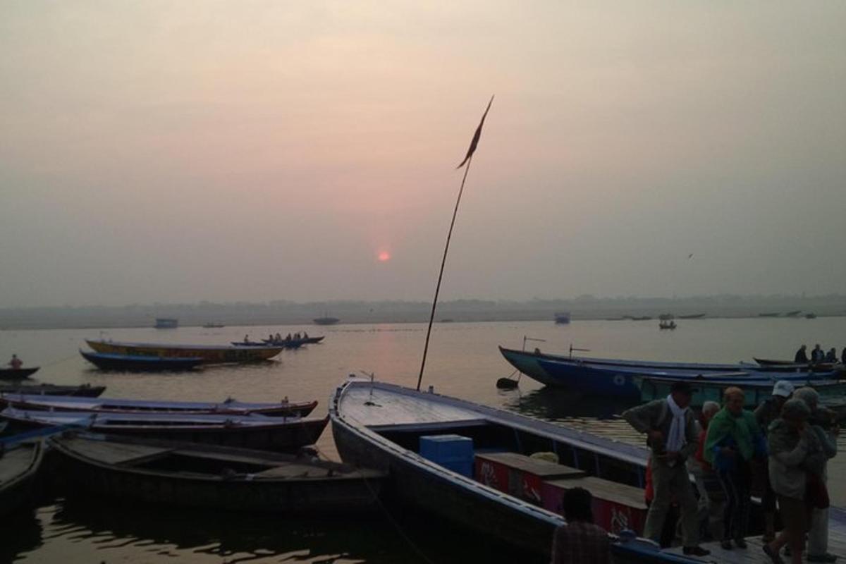 a group of people standing next to boats on the water