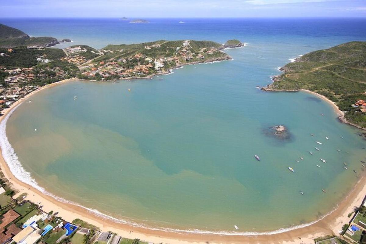 an aerial view of a beach with boats in the water