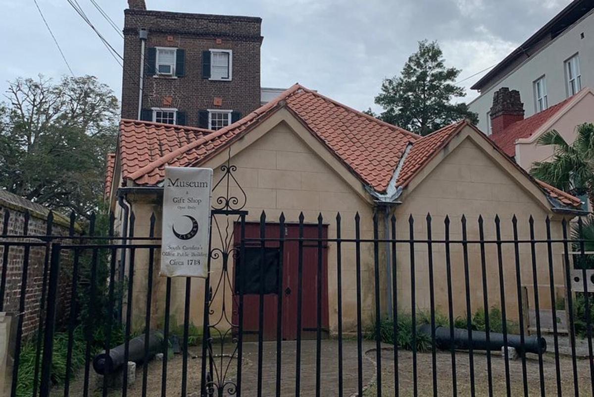a small house with a gate in front of it