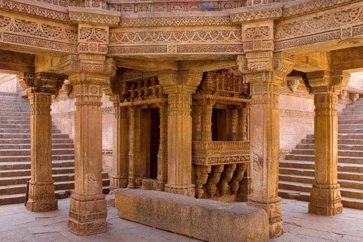 a stone building with columns and steps in front