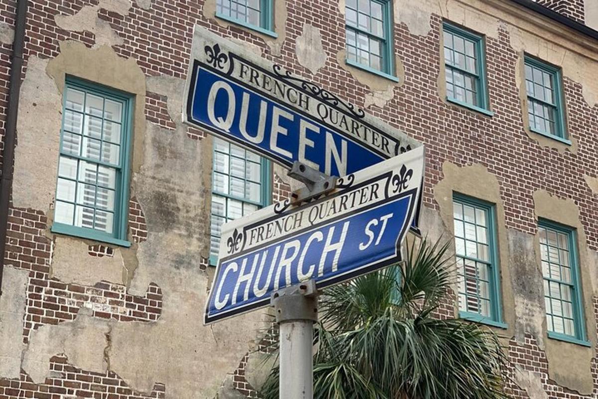 two street signs on a pole in front of a building