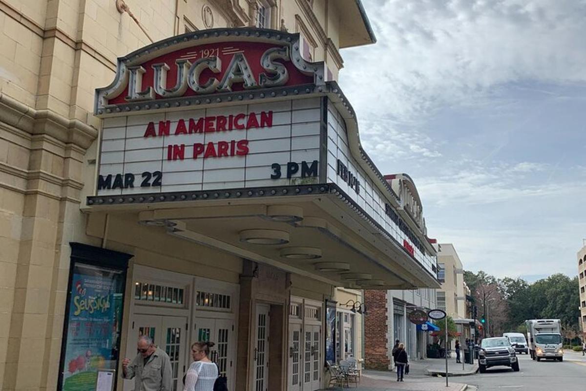 a building with a sign for a theater on a street