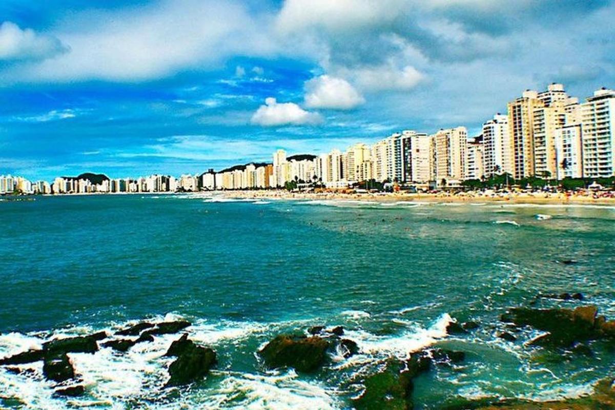 a view of a beach with buildings and the ocean