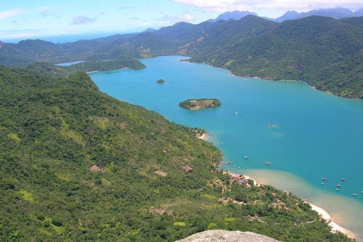 an aerial view of a lake in the mountains