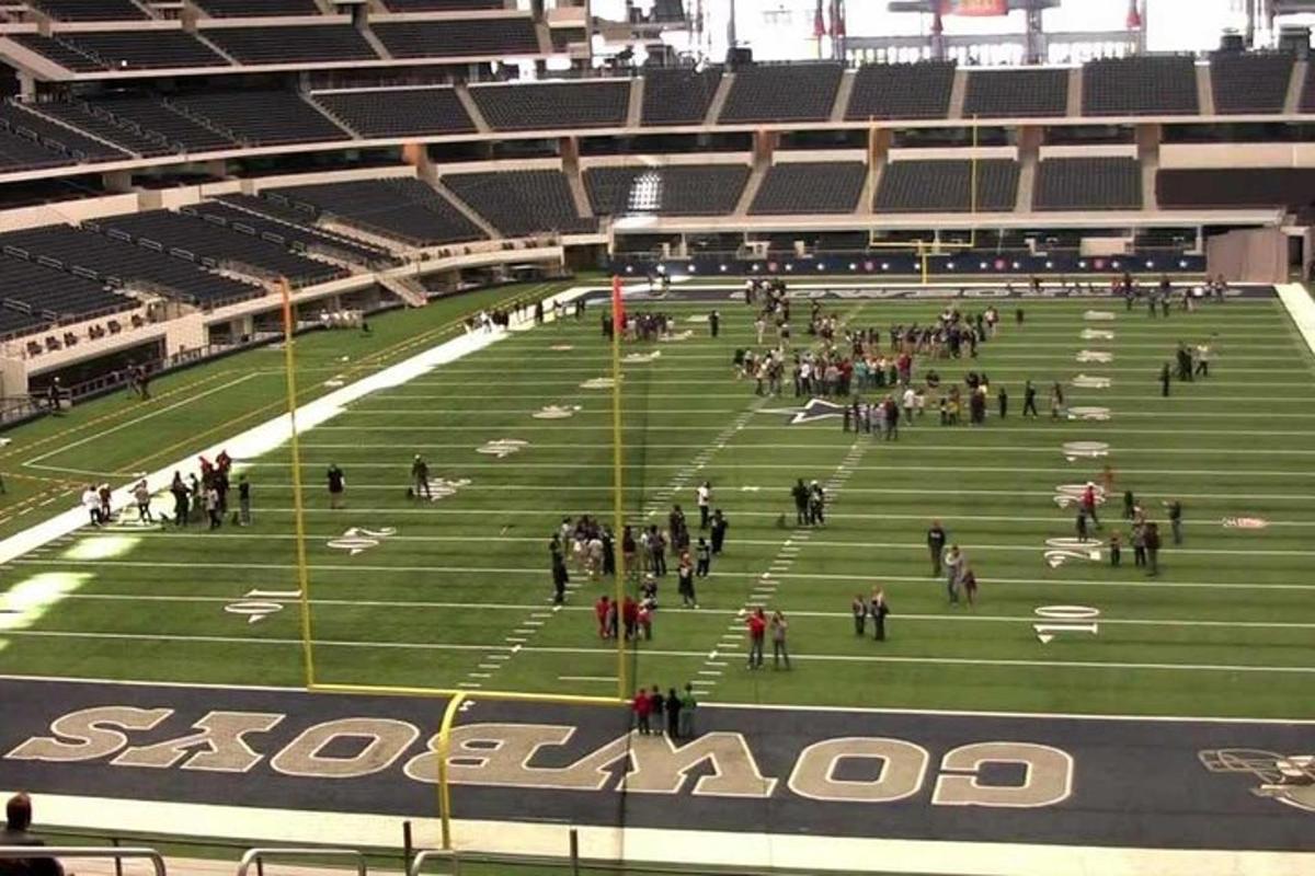 a group of people standing on a football field