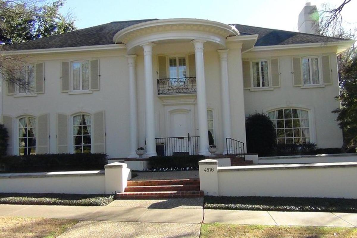 a large white house with a porch and columns