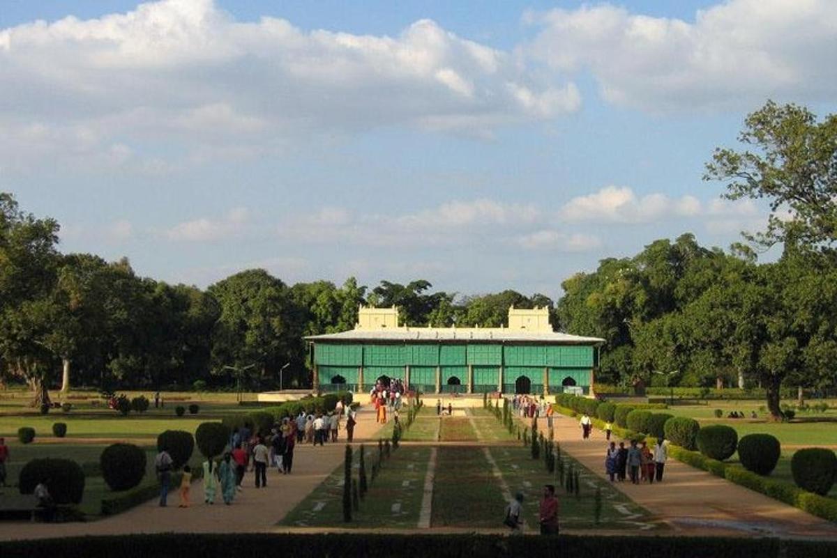 a group of people walking around a building in a park