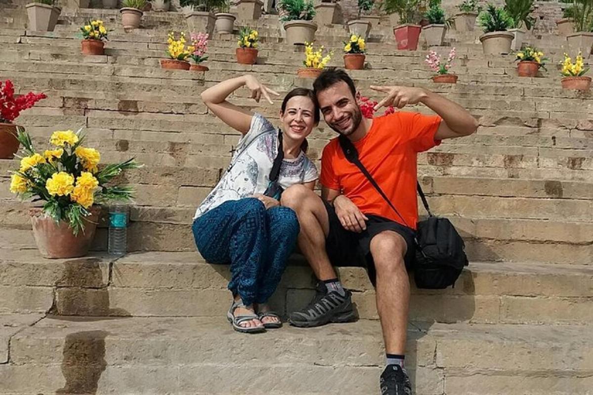 a man and a woman sitting on some steps