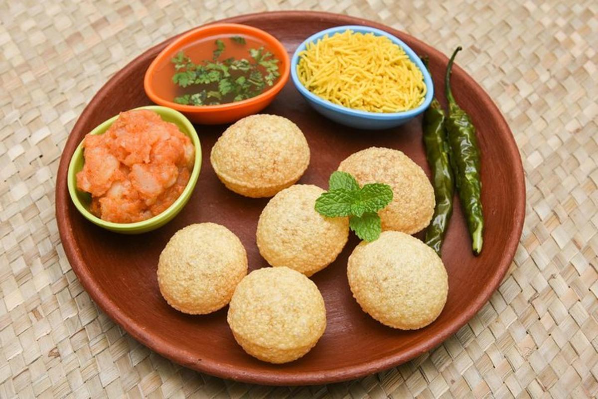 a plate of food with biscuits and dip and dips