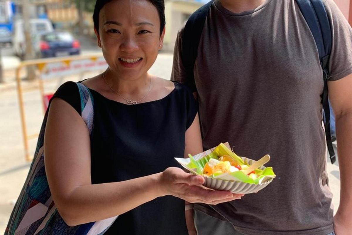 a woman holding a bowl of food with a man