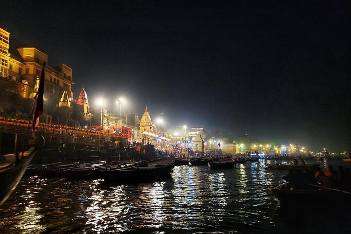 a group of boats in a river at night