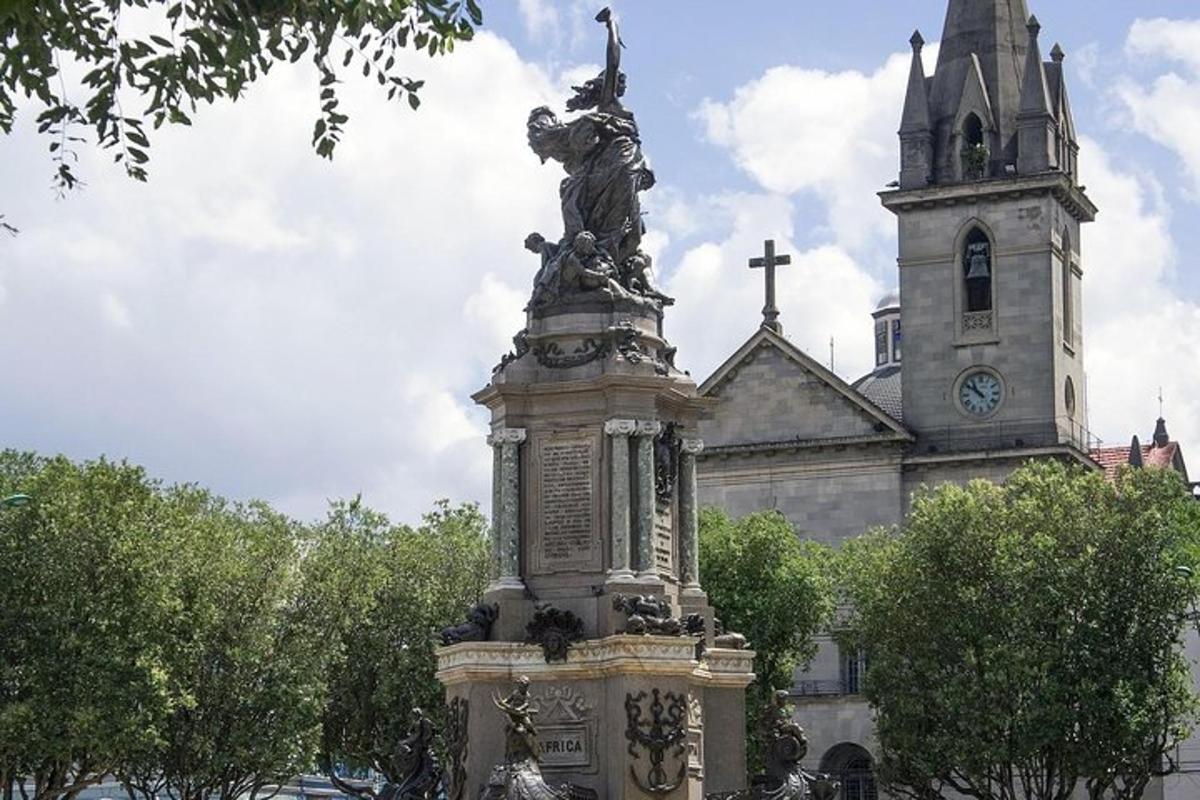 a statue in front of a building with a church