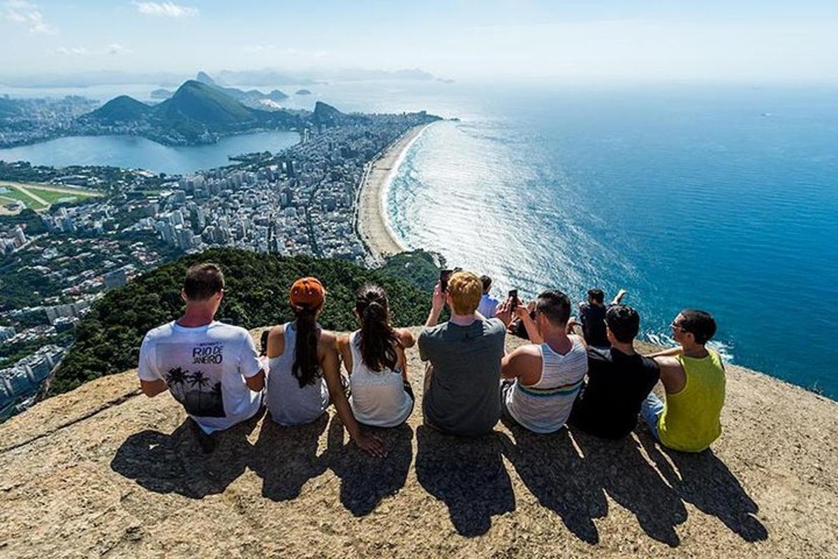 a group of people sitting on top of a mountain