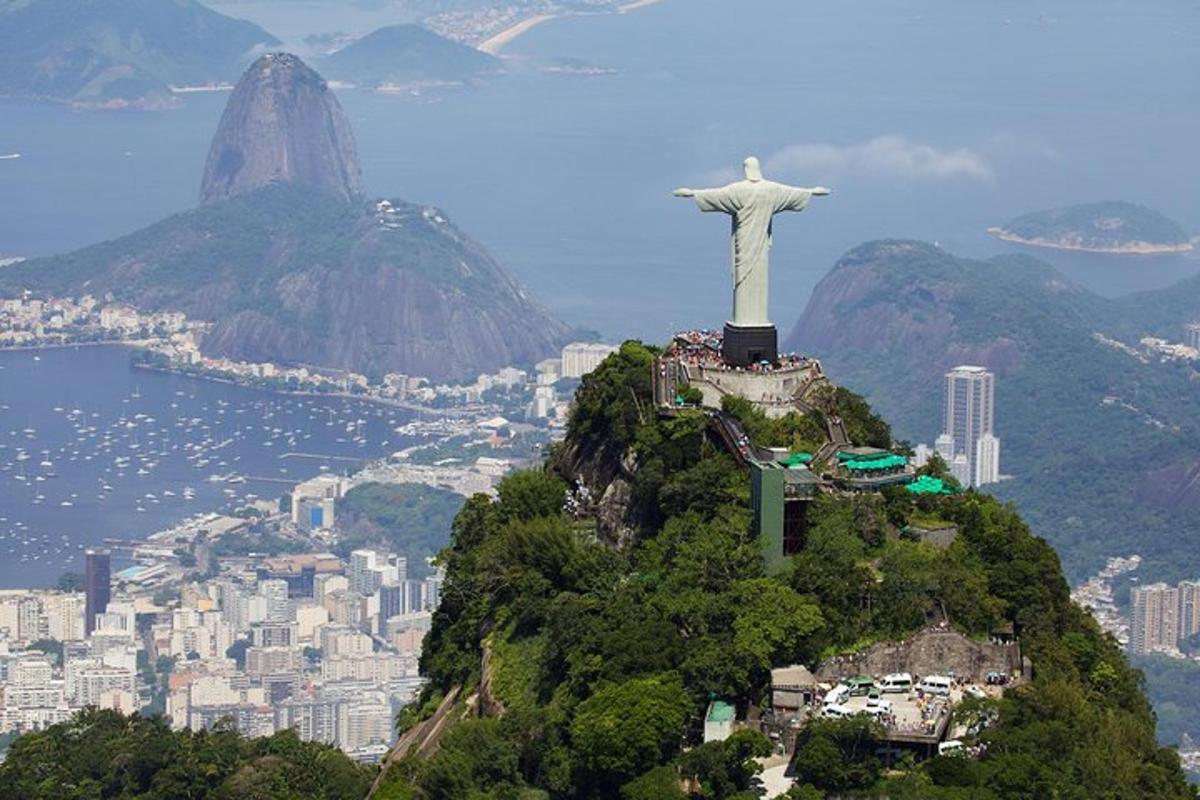 a statue of christ the redeemer on top of a mountain