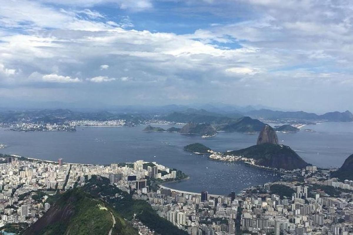 a view of a city with mountains and a body of water